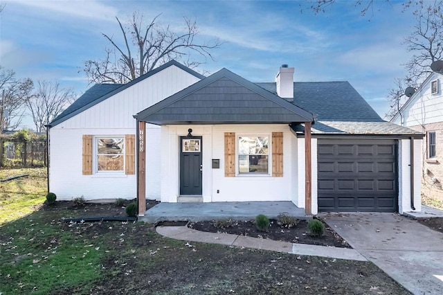 view of front of property with a garage and covered porch