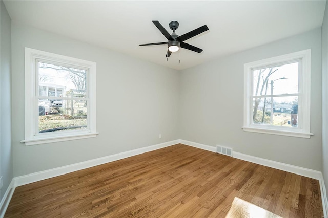 empty room featuring hardwood / wood-style floors and ceiling fan