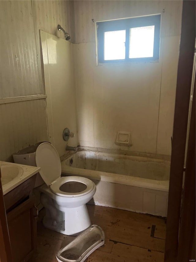 full bathroom featuring hardwood / wood-style floors, vanity, toilet, and shower / washtub combination