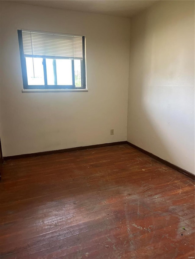 empty room with dark wood-type flooring