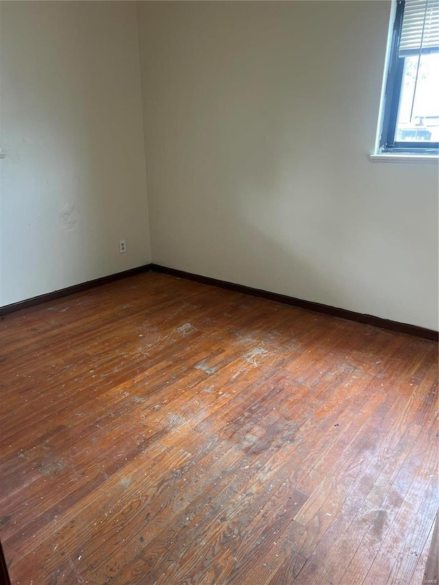 unfurnished room with hardwood / wood-style flooring