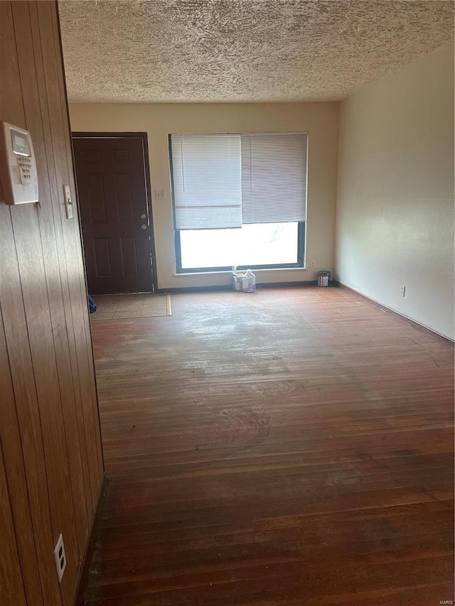 interior space with wood walls and dark hardwood / wood-style flooring