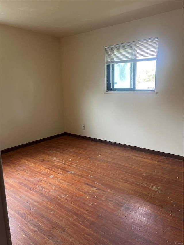 empty room with wood-type flooring