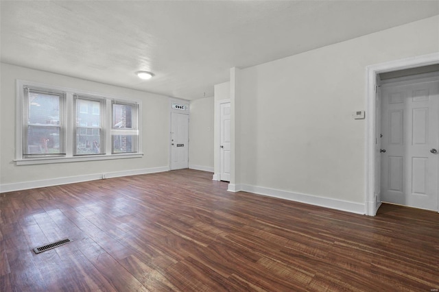 empty room featuring dark wood-type flooring