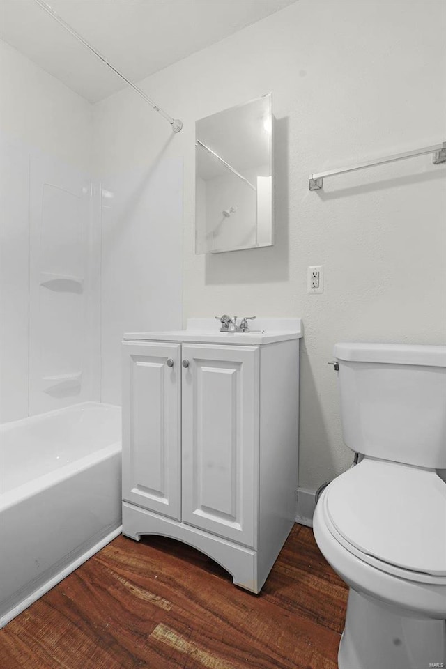 full bathroom with shower / bathing tub combination, hardwood / wood-style floors, vanity, and toilet