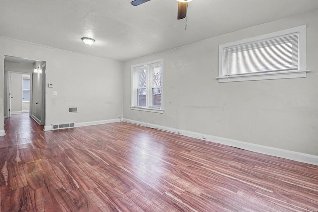 spare room featuring ceiling fan, hardwood / wood-style floors, and a textured ceiling