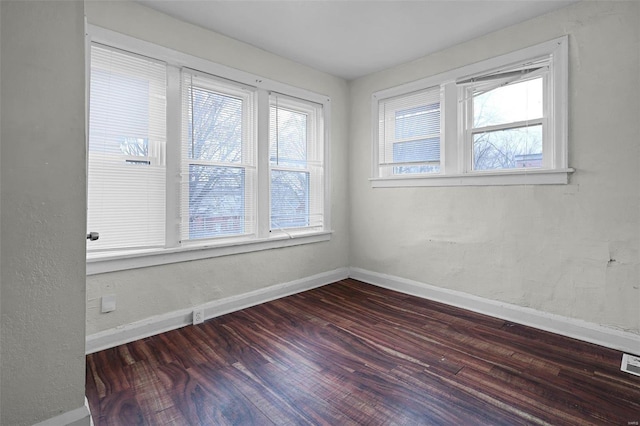 spare room with dark hardwood / wood-style flooring