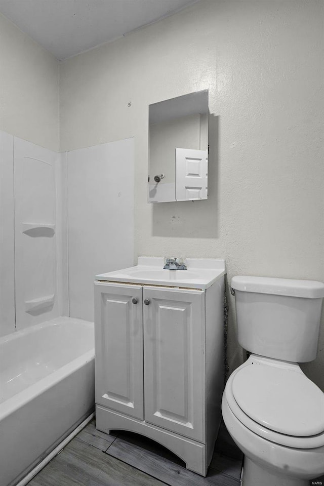 full bathroom with toilet, vanity, tub / shower combination, and hardwood / wood-style flooring