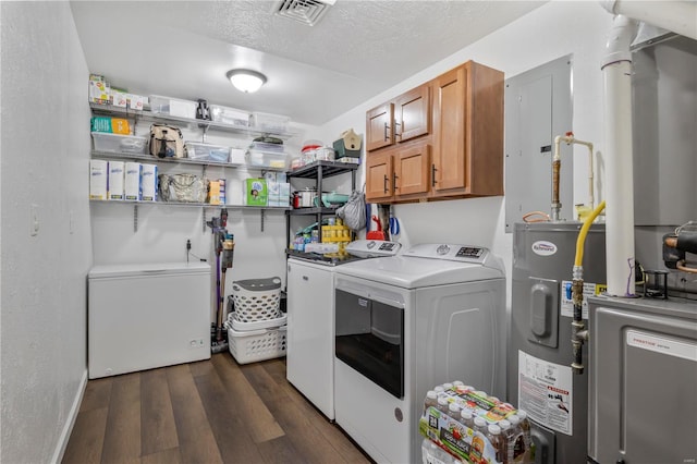 laundry area featuring visible vents, dark wood finished floors, a textured ceiling, electric water heater, and washer and clothes dryer