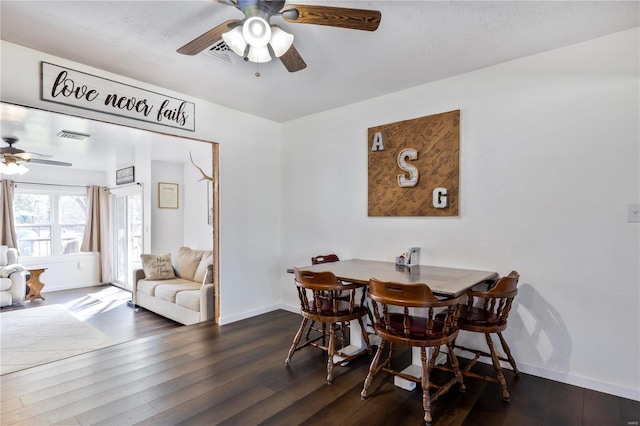 dining room featuring visible vents, baseboards, a ceiling fan, and hardwood / wood-style flooring