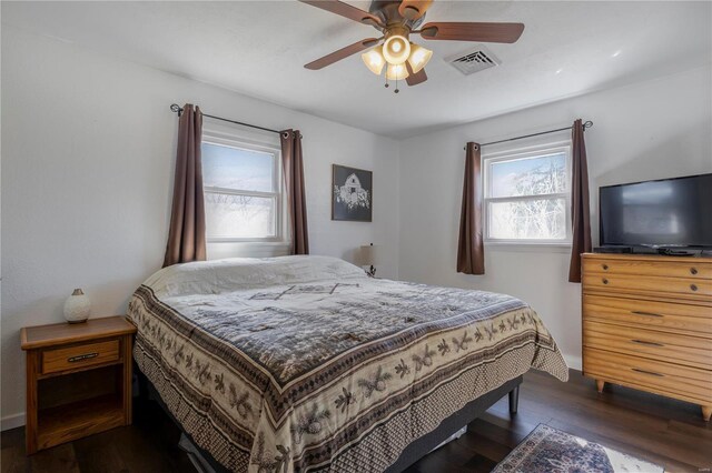 bedroom featuring visible vents, ceiling fan, and dark wood-style flooring