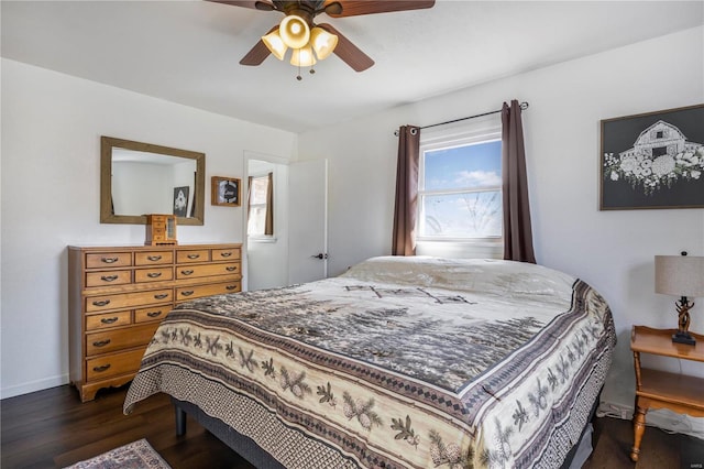 bedroom featuring dark wood finished floors, baseboards, and a ceiling fan