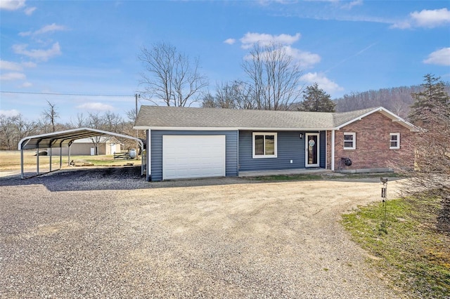 view of front of house featuring a garage, a detached carport, driveway, and a shingled roof