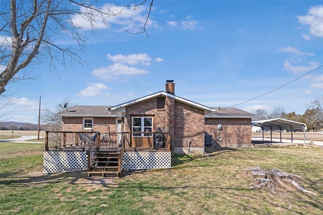 rear view of house with a carport, a yard, brick siding, and a chimney