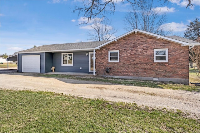 single story home with a front yard, driveway, an attached garage, a shingled roof, and brick siding