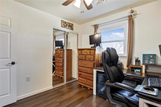 office featuring a ceiling fan, dark wood-style flooring, and baseboards