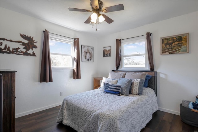 bedroom featuring baseboards, multiple windows, and dark wood-type flooring