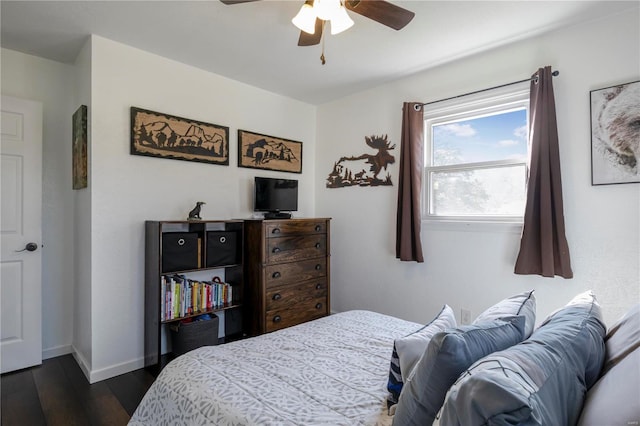 bedroom featuring a ceiling fan, baseboards, and dark wood-style flooring