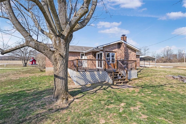 back of property featuring a carport, a yard, brick siding, and a chimney