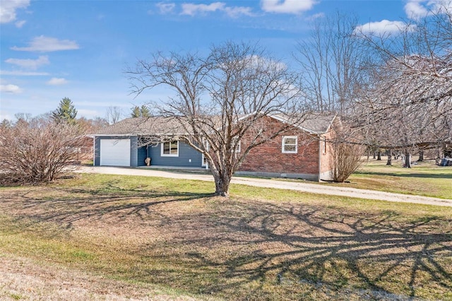 ranch-style house featuring a garage, brick siding, and a front lawn