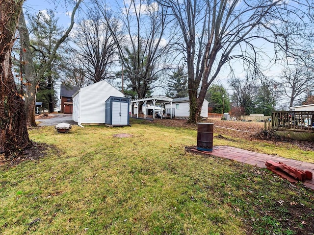 view of yard featuring a shed and a wooden deck