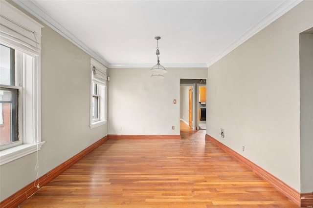 unfurnished room featuring light wood-type flooring and ornamental molding