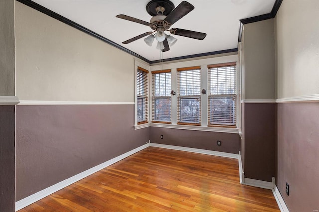 empty room featuring hardwood / wood-style flooring, ceiling fan, and ornamental molding