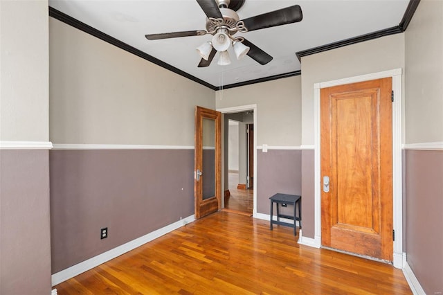 unfurnished bedroom featuring ceiling fan, hardwood / wood-style floors, and ornamental molding