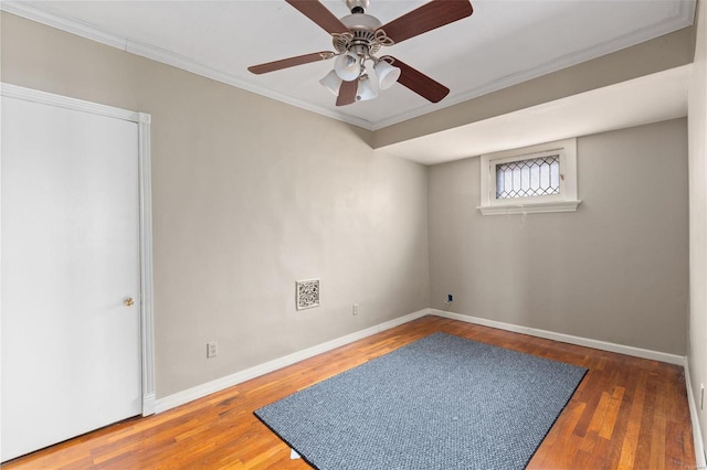 spare room with ornamental molding, ceiling fan, and dark wood-type flooring