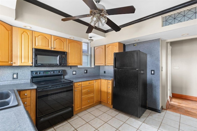 kitchen featuring light tile patterned floors, black appliances, and ornamental molding