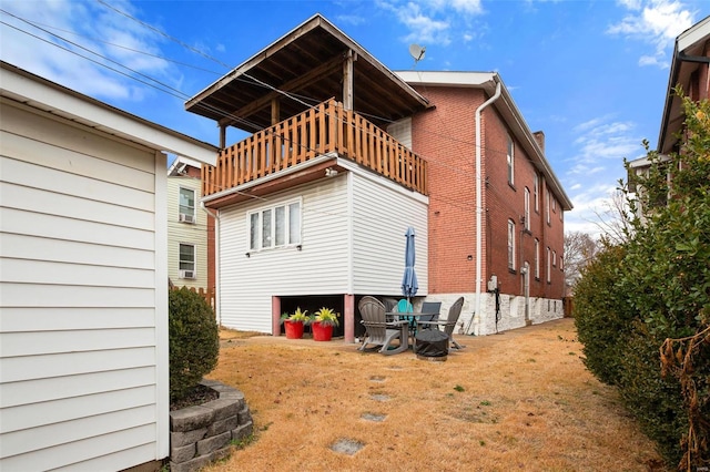 back of property featuring a balcony