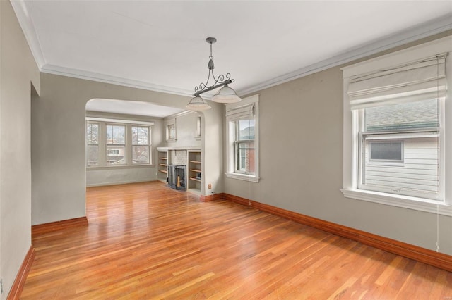 unfurnished living room featuring ornamental molding and light hardwood / wood-style flooring