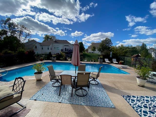 view of pool featuring a diving board and a patio area