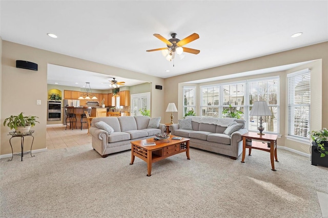 living room featuring ceiling fan and light colored carpet