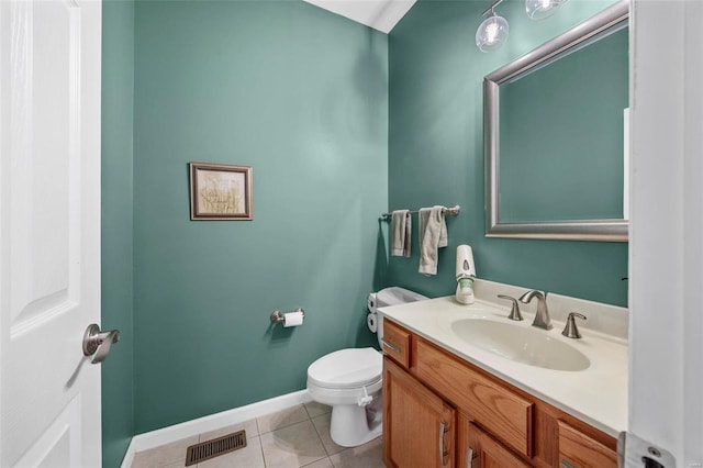 bathroom featuring tile patterned floors, vanity, and toilet