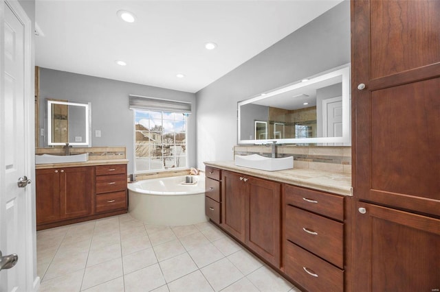 bathroom with decorative backsplash, tile patterned flooring, vanity, and shower with separate bathtub