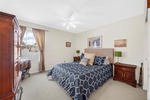 bedroom with light colored carpet and ceiling fan