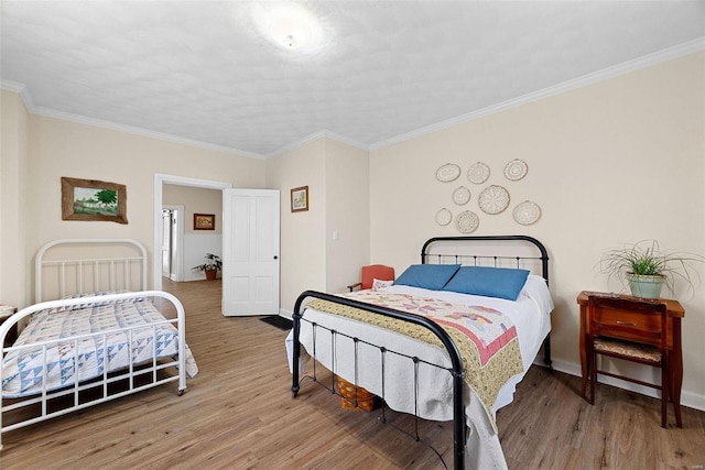 bedroom featuring light hardwood / wood-style floors and ornamental molding