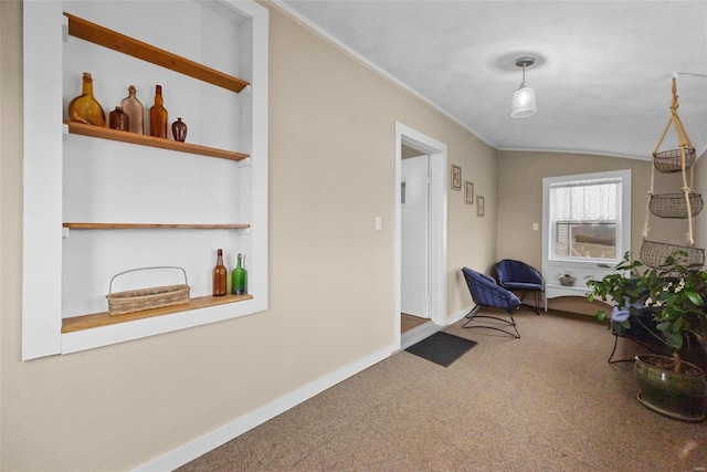 sitting room featuring carpet floors and lofted ceiling