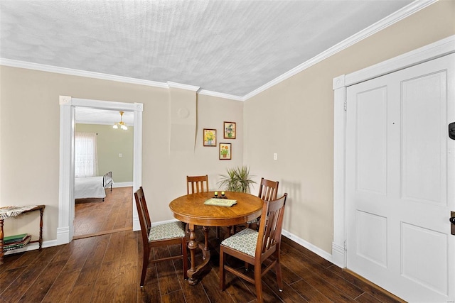 dining room with a textured ceiling, dark hardwood / wood-style floors, and ornamental molding