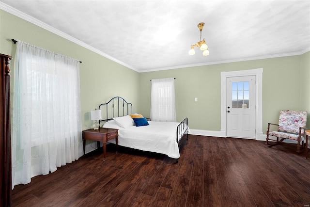 bedroom with dark hardwood / wood-style flooring, ornamental molding, and a chandelier