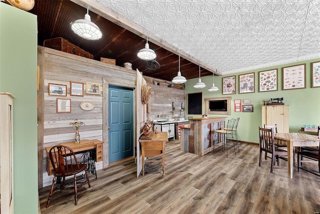 interior space with hardwood / wood-style flooring, wooden walls, wooden ceiling, and high vaulted ceiling