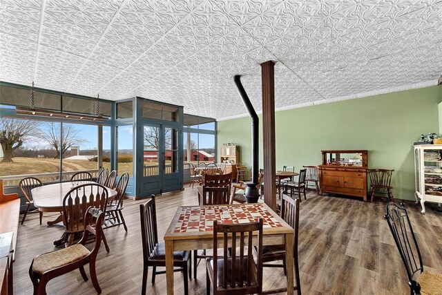 dining area with hardwood / wood-style flooring and a wall of windows