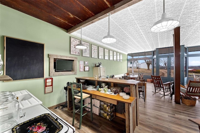 kitchen featuring floor to ceiling windows and hardwood / wood-style floors