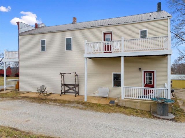 rear view of house featuring a balcony