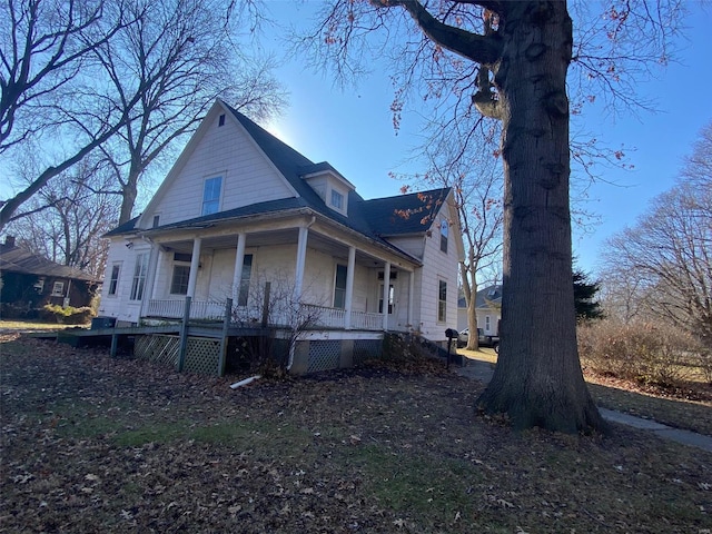 view of property exterior with a porch