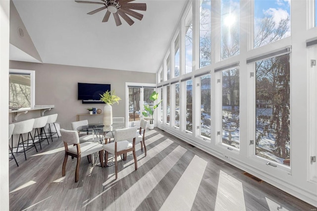 sunroom / solarium featuring ceiling fan and lofted ceiling