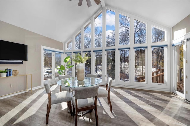 sunroom / solarium with ceiling fan, a wealth of natural light, and lofted ceiling