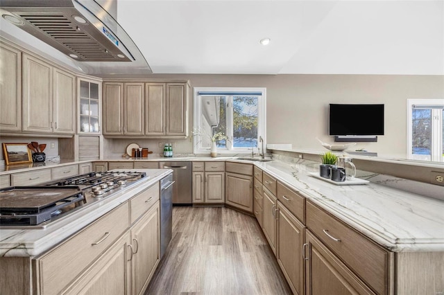 kitchen featuring light brown cabinets, stainless steel gas stovetop, sink, light wood-type flooring, and range hood