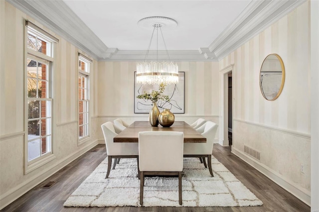 dining area featuring crown molding, an inviting chandelier, and dark hardwood / wood-style flooring